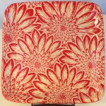 Stoneware plate, sgraffito carved mums design