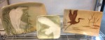 Display of stoneware platters and plate, sgraffito carved egrets