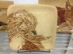 Stoneware plate, sgraffito carved hawk design