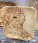 Stoneware plate, sgraffito carved hawk design