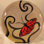 Round stoneware plate with sgraffito carved monarch butterfly design