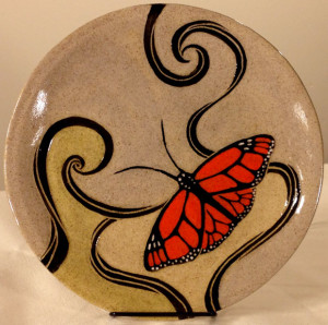 Round stoneware plate with sgraffito carved monarch butterfly design