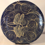 Round stoneware plate with sgraffito carved dragonfly and water motif