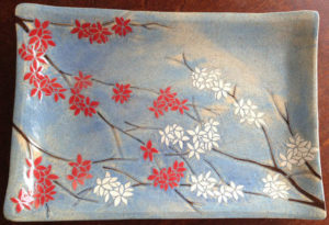 Stoneware platter, sgraffito blossoms design