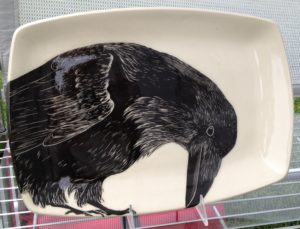 Stoneware platter, sgraffito carved raven design