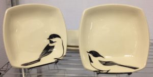 Two stoneware bowls with sgraffito carved chickadee designs