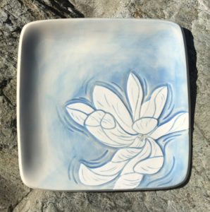 Square stoneware plate, sgraffito carved magnolia motif