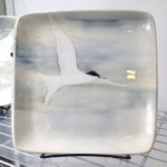 Stoneware plate, sgraffito carved arctic tern motif