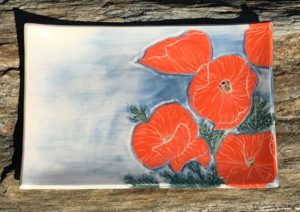 Stoneware platter, sgraffito carved poppies design