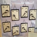 Collection of hanging tiles, sgraffito carved chickadee designs