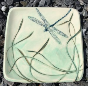 Stoneware plate, sgraffito carved dragonfly and grasses