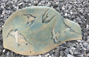 Decorative stoneware tile, swallows in flight