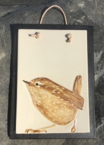 Stoneware tile, sgraffito carved wren design